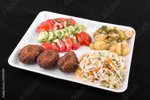 fried meatballs with salad and potatoes