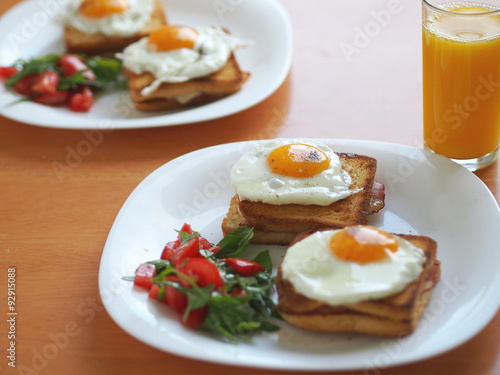 Croque madame (baked or fried boiled ham and cheese sandwich with topped with fried egg).