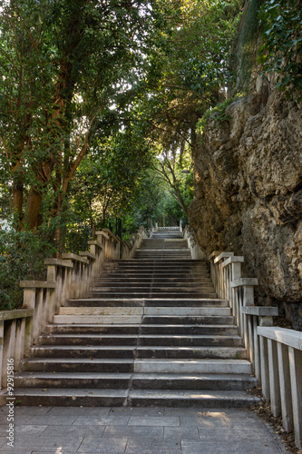 Long flight of stony steps to the Marjan hill surrounded by trees and rock in Split, Croatia. © tuomaslehtinen