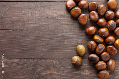 Delicious roasted chestnuts on the wooden background