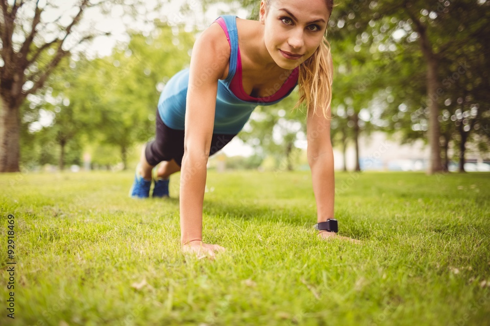 Portrait of confident woman exercising on grass Portrait of confident woman exercising on grass