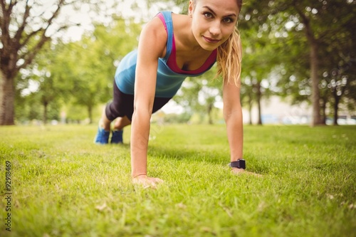 Portrait of confident woman exercising on grass 