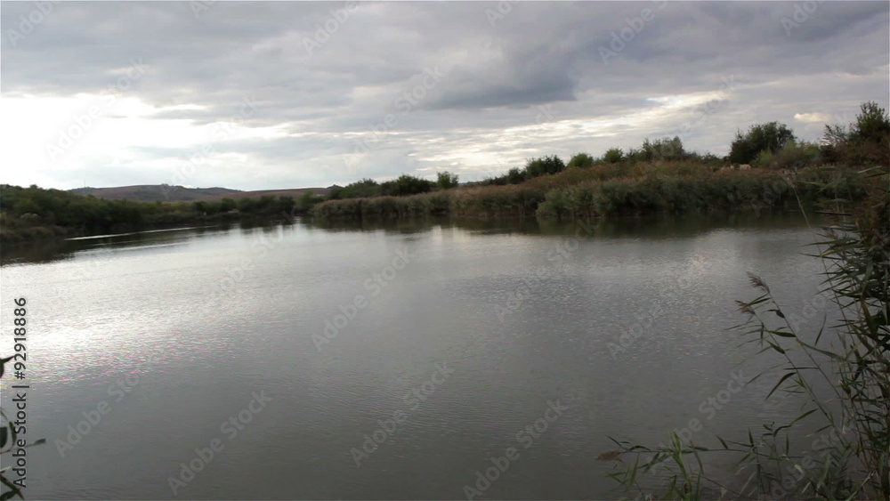 Lake in the evening/over the lake comes the evening and rain clouds in the sky Lake in the evening/over the lake comes the evening and rain clouds in the sky