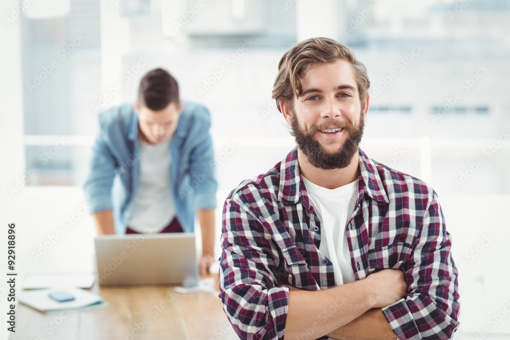 Portrait of smiling businessman standing with arms crossed Portrait of smiling businessman standing with arms crossed