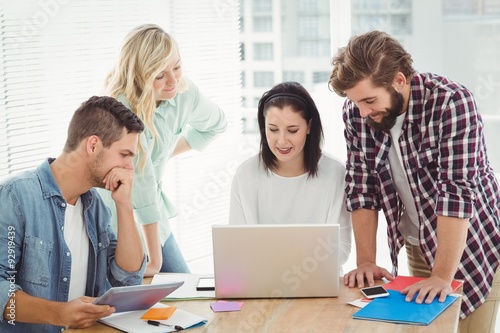 Creative business people working on laptop 