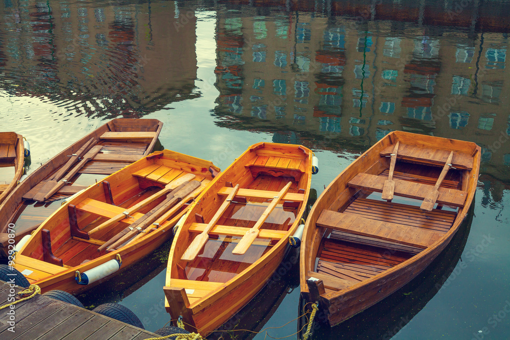 Wooden boats on the canal. Buildings reflection