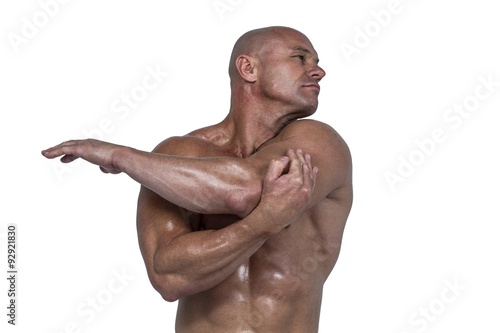 Muscular man stretching hands