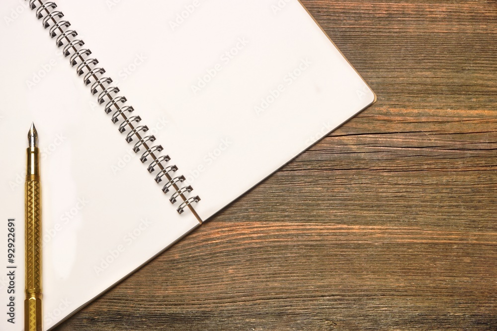 Notebook With Blank Page And Golden Pen On Wood Table Notebook With Blank Page And Golden Pen On Wood Table