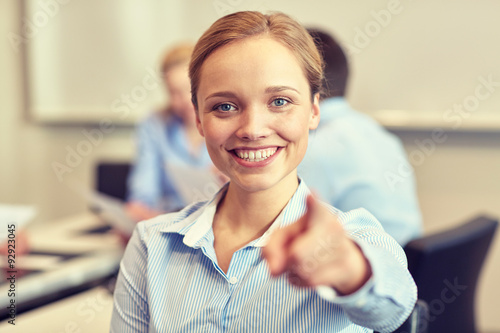 smiling businesswoman pointing finger on you