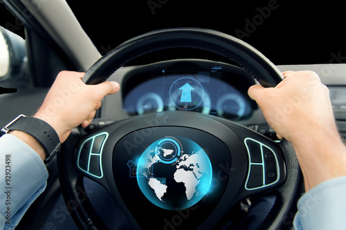 close up of man driving car with globe on screen © Syda Productions