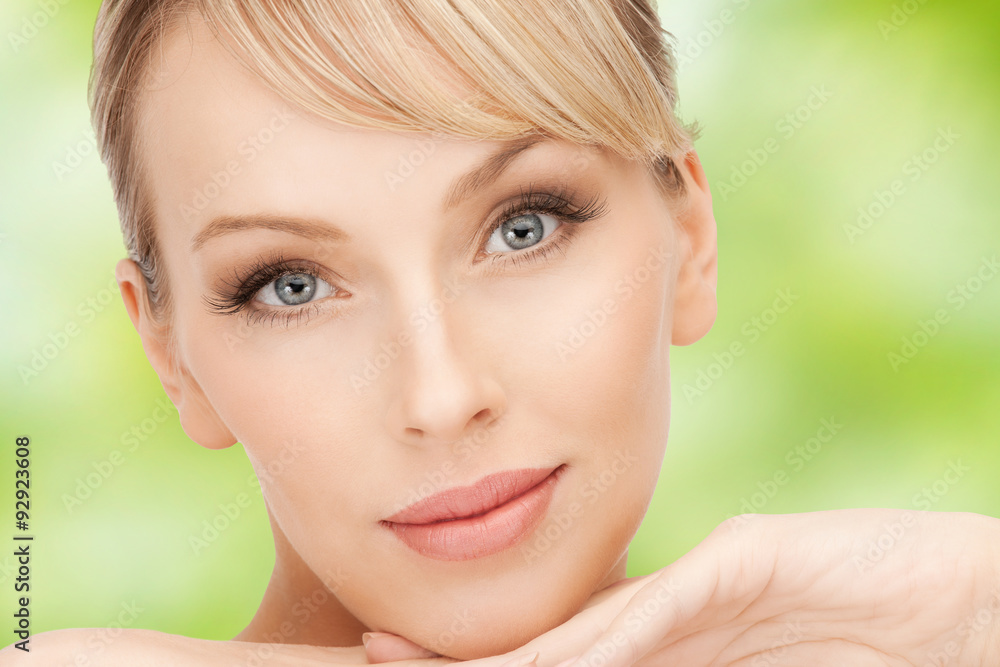beautiful young woman face over green background beautiful young woman face over green background