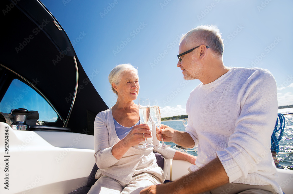 Fototapeta premium senior couple clinking glasses on boat or yacht