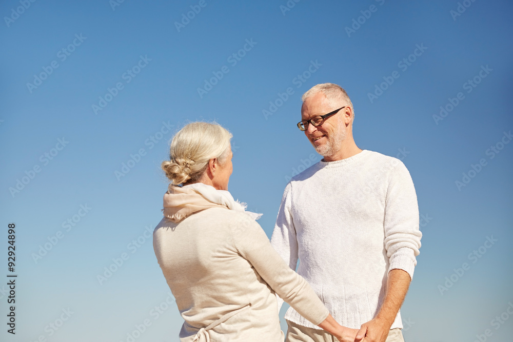 happy senior couple holding hands outdoors happy senior couple holding hands outdoors