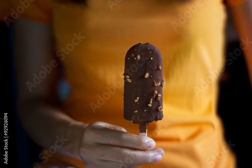 woman with ice cream covered chocolate and almonds on dark background © ipopba