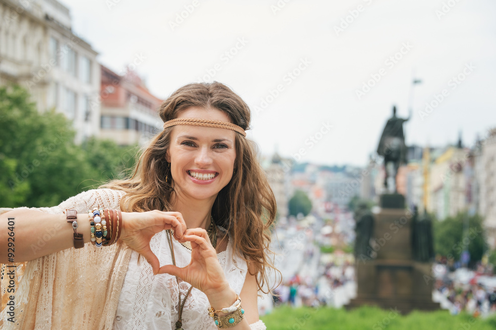 Fototapeta premium Bohemian woman tourist in Prague showing heart shaped hands