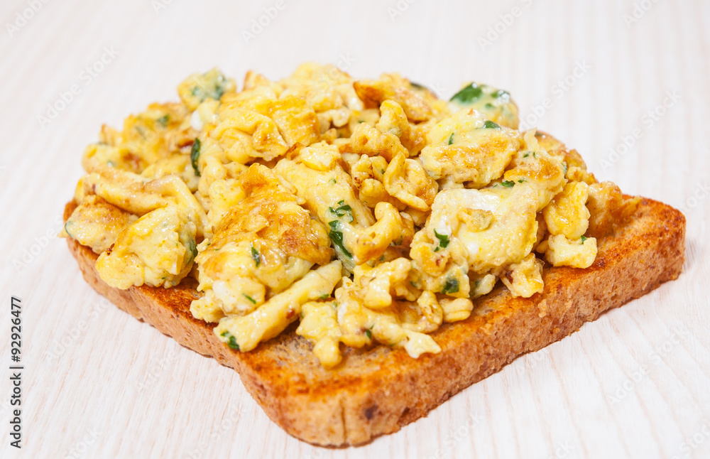 Scrambled eggs on toasted bread. Scrambled eggs on toasted bread.