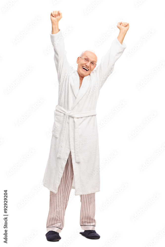 Senior in a white bathrobe stretching himself Senior in a white bathrobe stretching himself