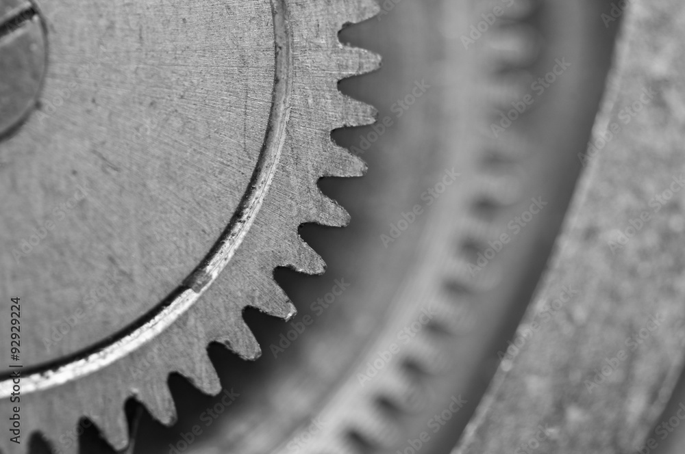 Black-and-white Metal Cogwheels in Clockwork. Macro Black-and-white Metal Cogwheels in Clockwork. Macro