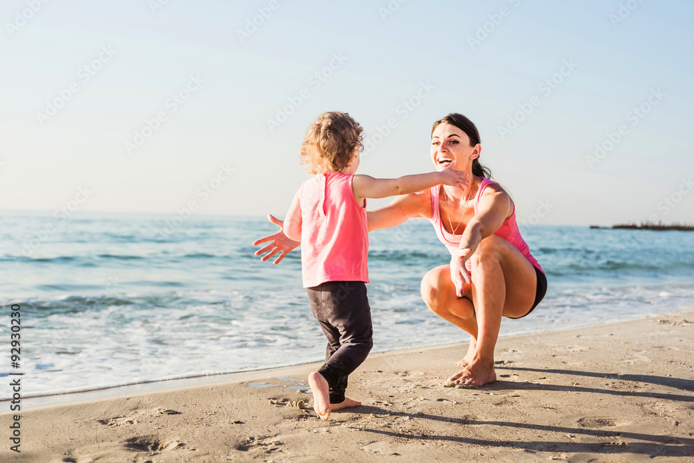 mother and daughter having fun on beach