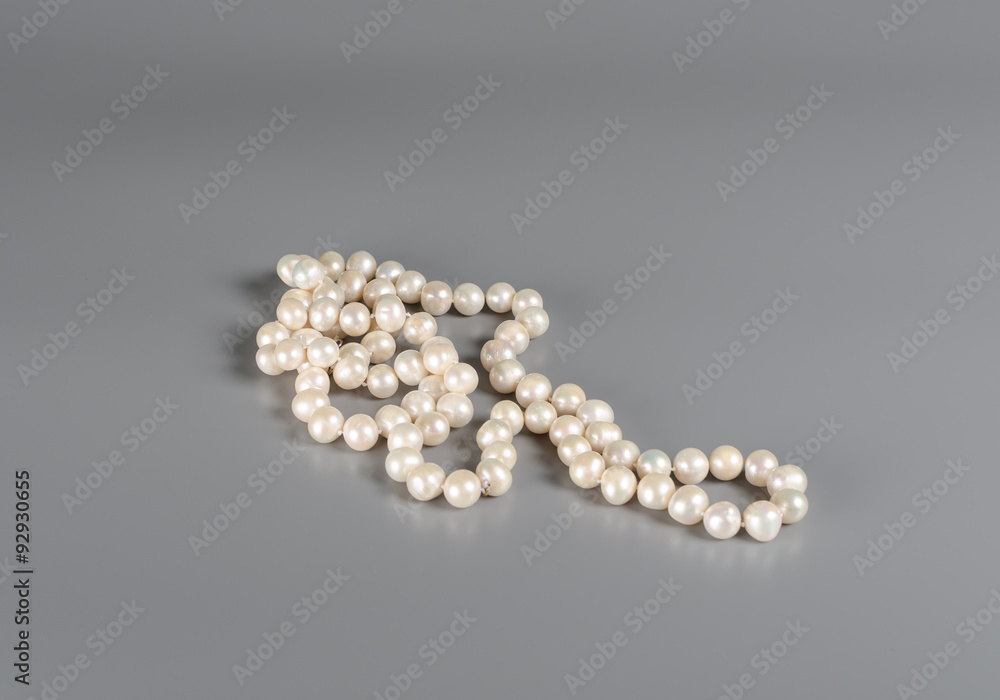 pearl necklace on gray background pearl necklace on gray background