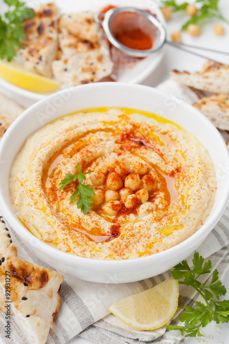 Hummus or houmous, appetizer made of mashed chickpeas with tahini, lemon, garlic, olive oil, parsley and paprika