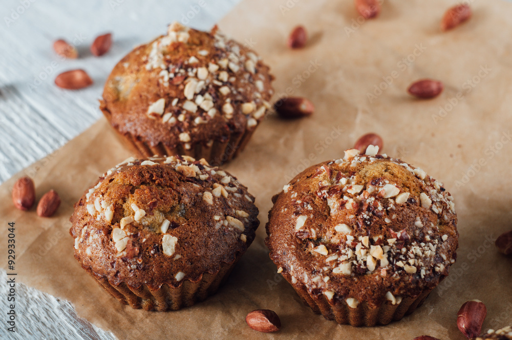 Homemade banana peanut muffins on baking paper Homemade banana peanut muffins on baking paper