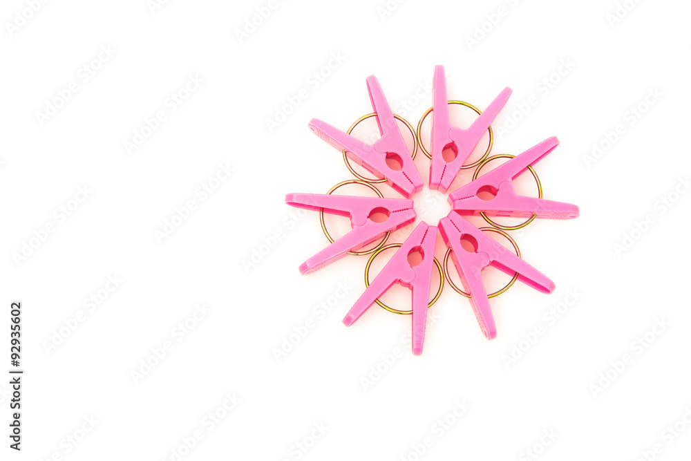 Fototapeta premium pink clothespins line up as a circle on a white background