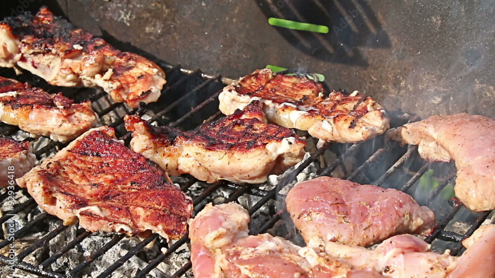 Roasted steaks on barbecue grill in the family garden Roasted steaks on barbecue grill in the family garden