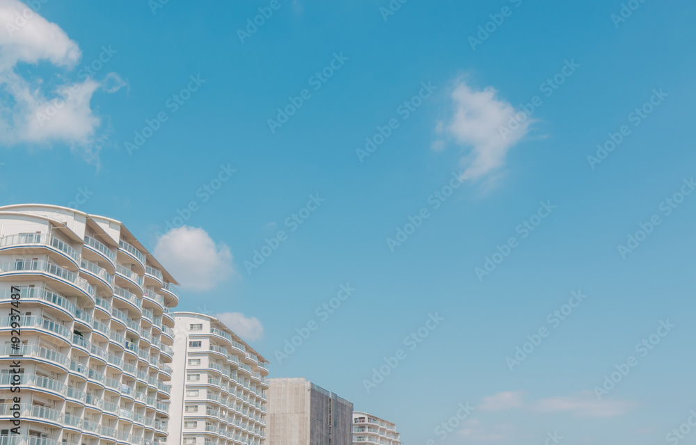 Apartments in lined against blue sky in the background. Apartments in lined against blue sky in the background.