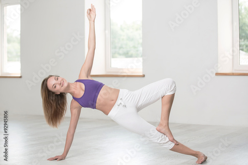 Happy woman doing yoga exercises