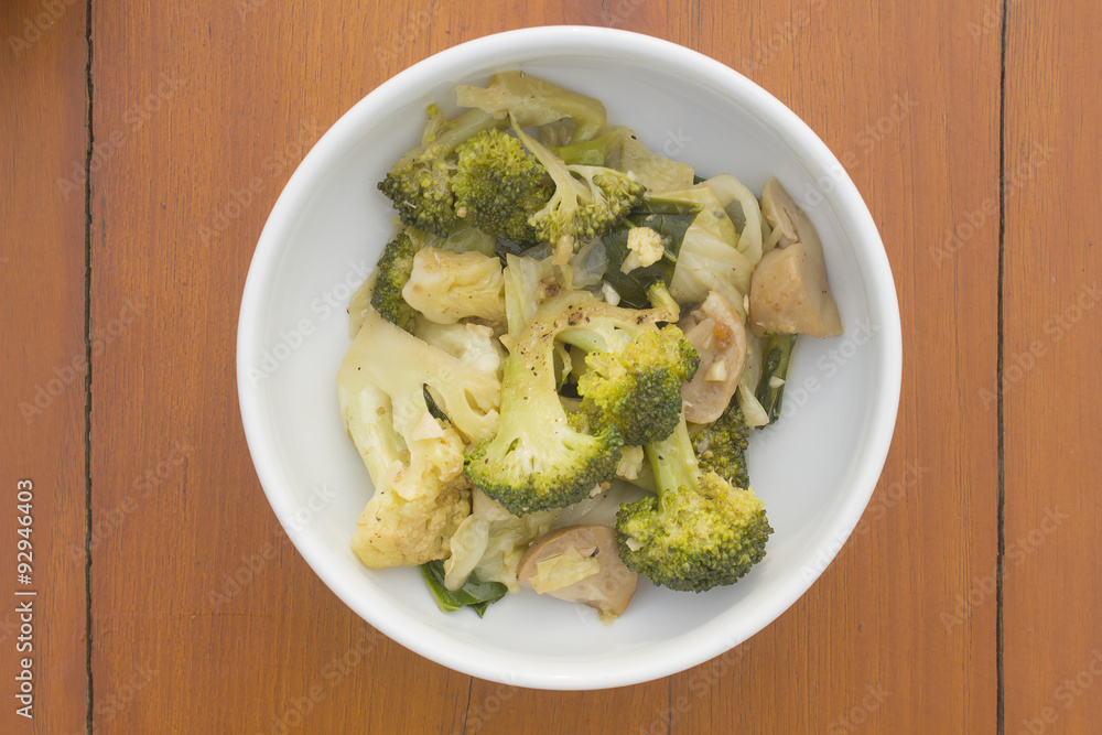 stir fried vegetable in white bowl on wooden table stir fried vegetable in white bowl on wooden table