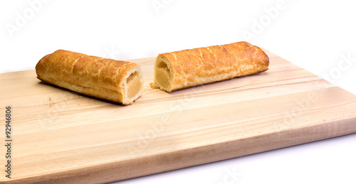 Two pieces of an almond bar on a wooden plate photo