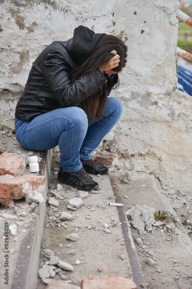 Drug overdose concept - young depressive woman stand on the step Drug overdose concept - young depressive woman stand on the step