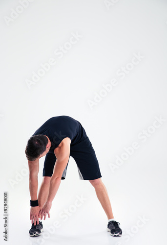 Athletic man doing warm up exercises