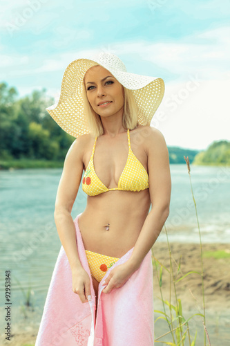 cute blond girl in bikini and hat. portrait of a beautiful young girl