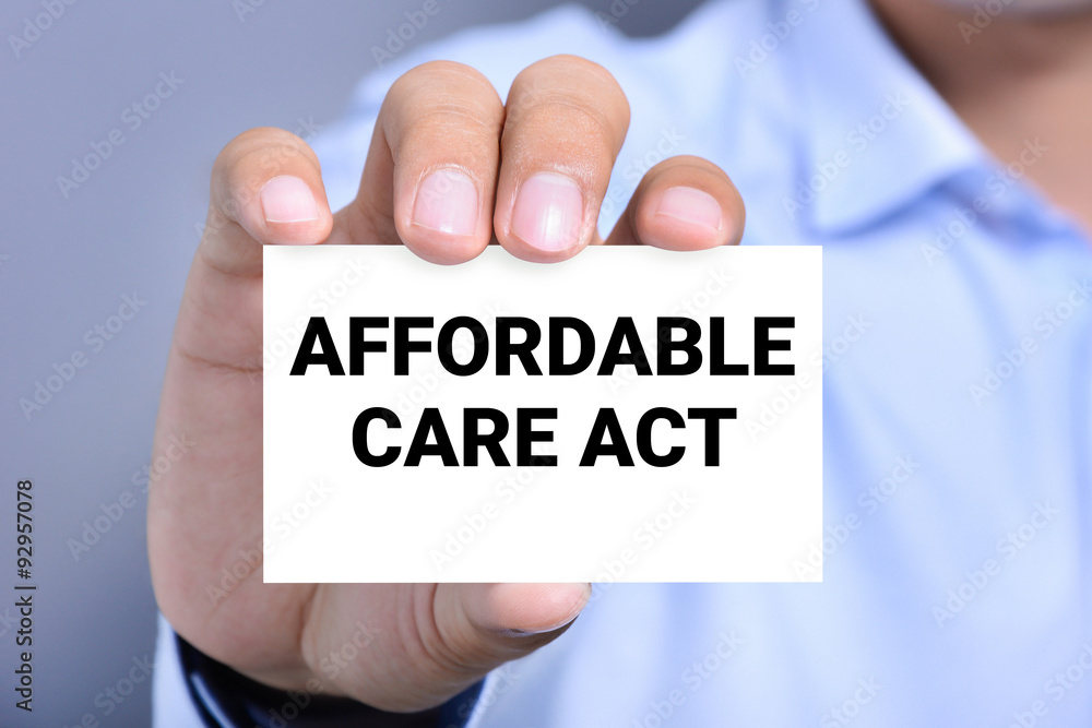 AFFORDABLE CARE ACT (or ACA) message on the card shown by a man AFFORDABLE CARE ACT (or ACA) message on the card shown by a man