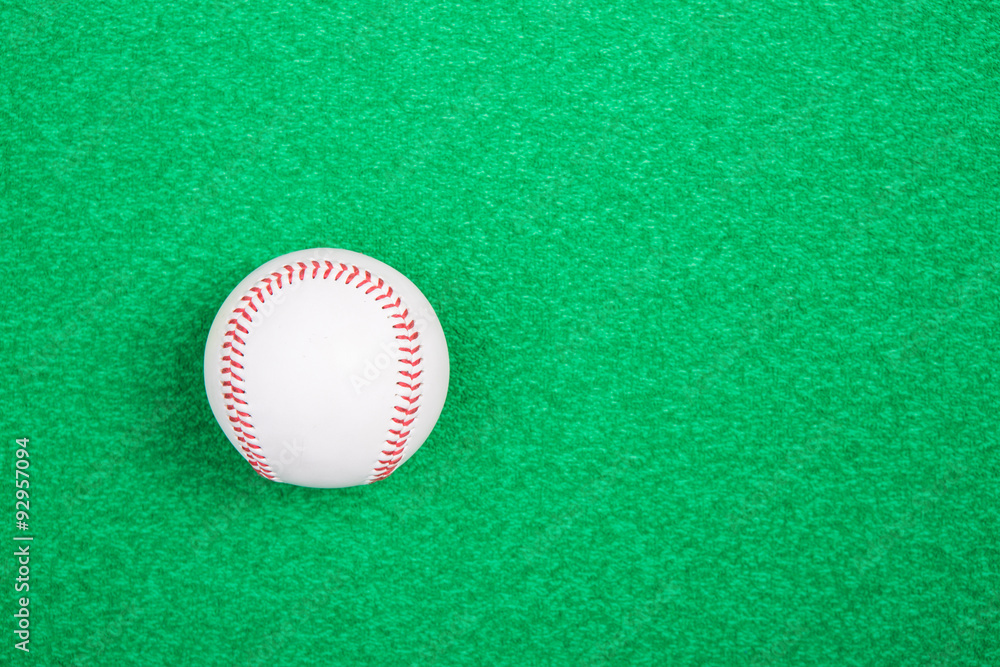 A white used baseball on the fresh green grass A white used baseball on the fresh green grass