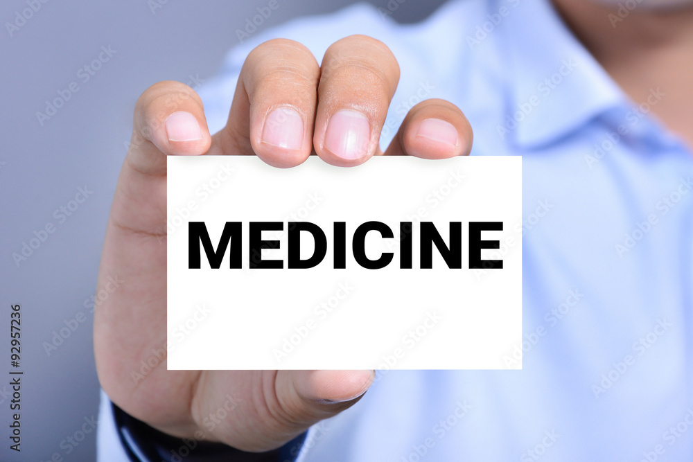 MEDICINE word on the card shown by a man MEDICINE word on the card shown by a man
