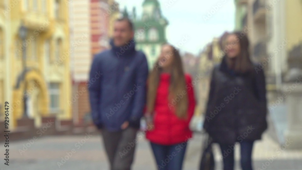 Tourist family walking by the city. Amazed Girl showing landmarks Tourist family walking by the city. Amazed Girl showing landmarks