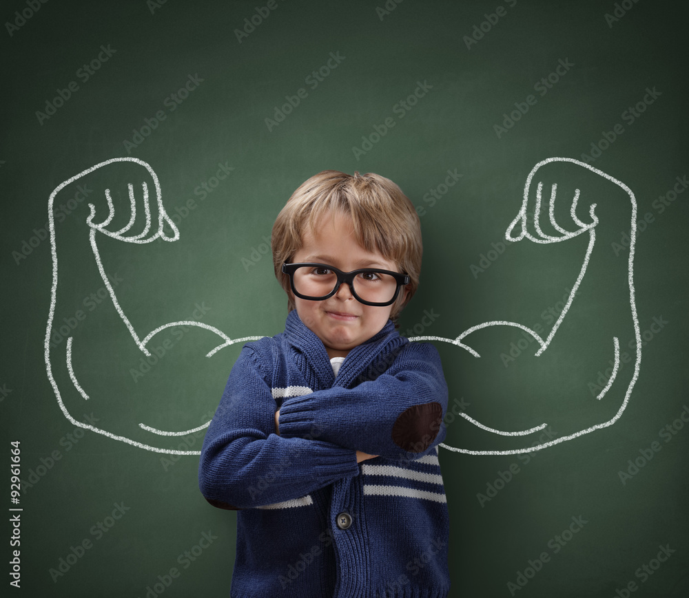 Strong man child showing bicep muscles