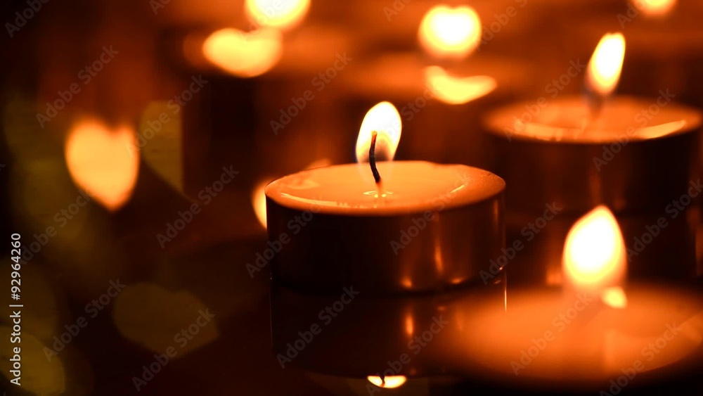 Golden candles light. Burning of candles background. Valentine's day Golden candles light. Burning of candles background. Valentine's day