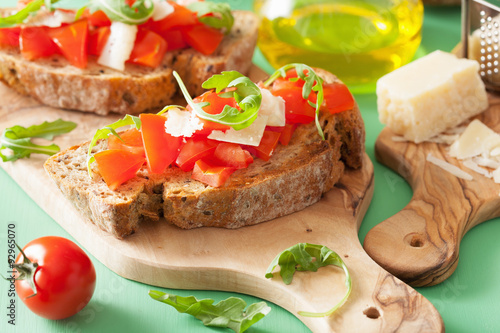 italian bruschetta with tomatoes parmesan arugula