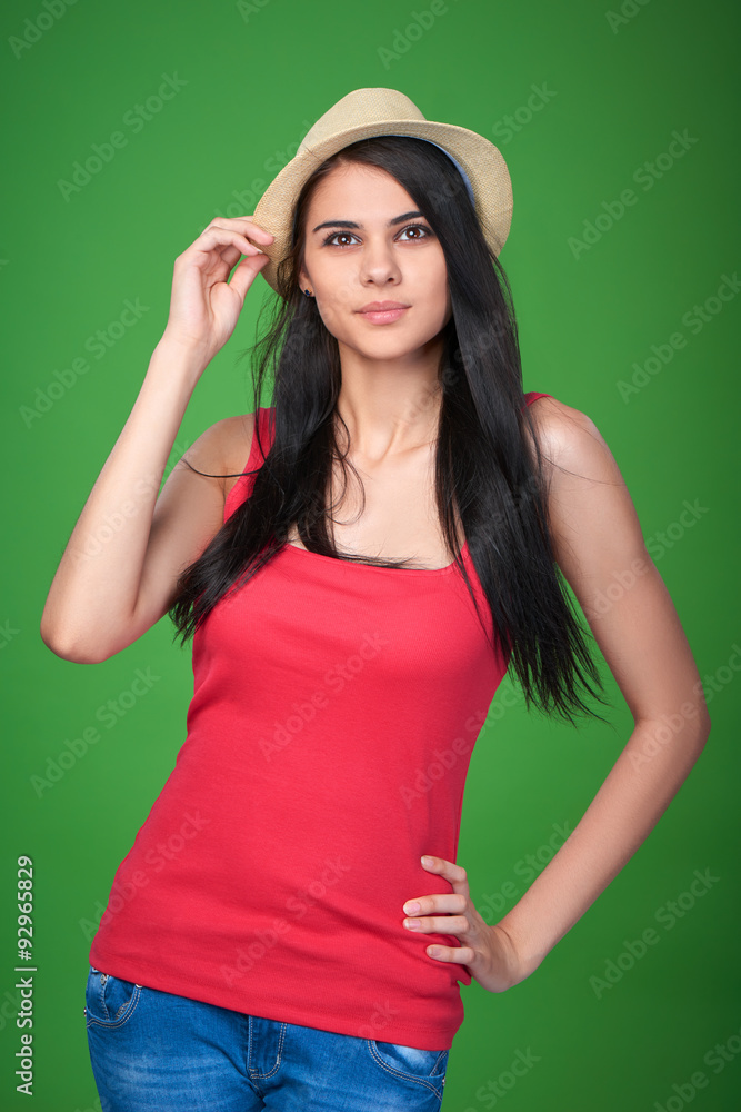 Naklejka premium Teen girl wearing straw hat looking up