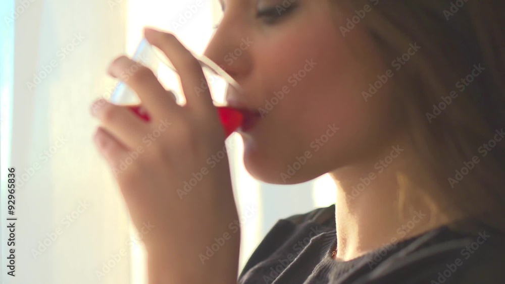 Beautiful young woman drinking tea and enjoying the sunrise. Beautiful young woman drinking tea and enjoying the sunrise.