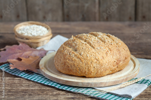 Homemade oatmeal bread with whole wheat flour on the old table