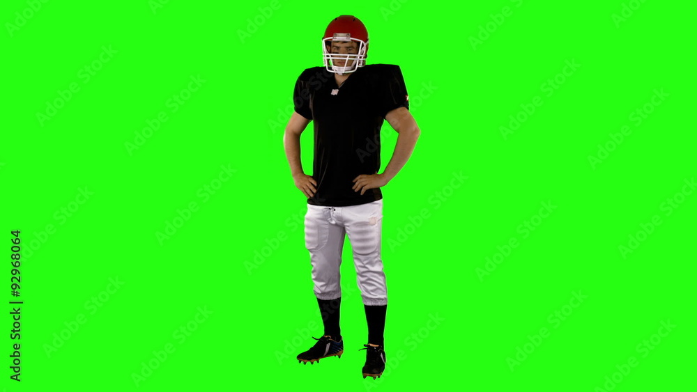 American football player with hands on hips American football player with hands on hips