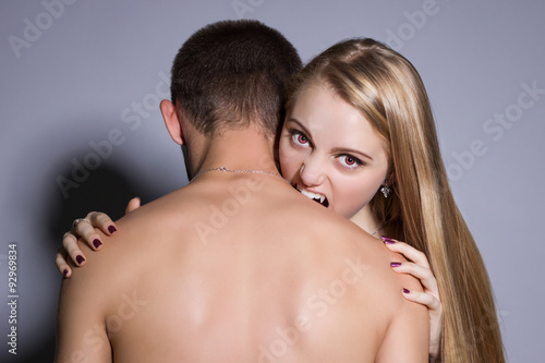 woman vampire bites a man's neck