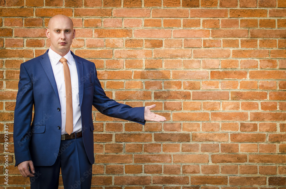 Young fashionable men in a suit against brick wall Young fashionable men in a suit against brick wall