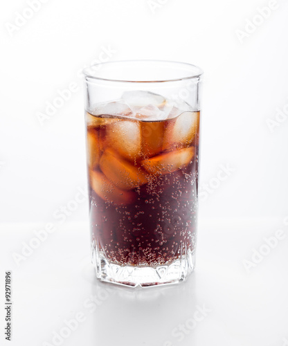 Cola glass with ice cubes on a white background