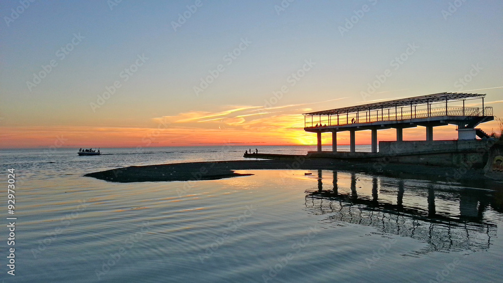 Fototapeta premium The river and the sea at sunset, seaside Sochi, Russia